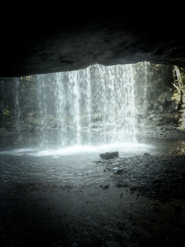 A waterfall seen from inside a cave