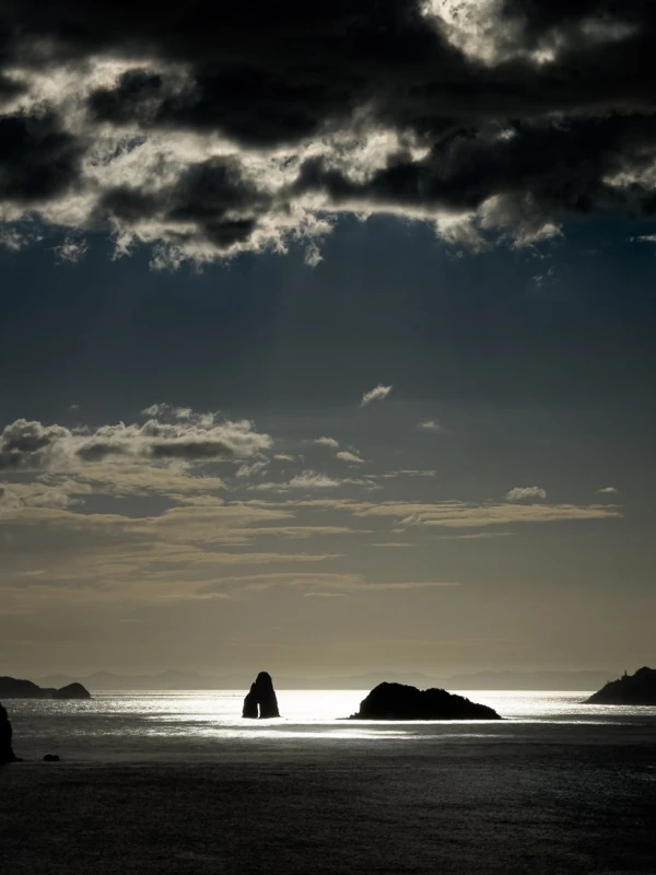 Islands in a calm sea under dark clouds