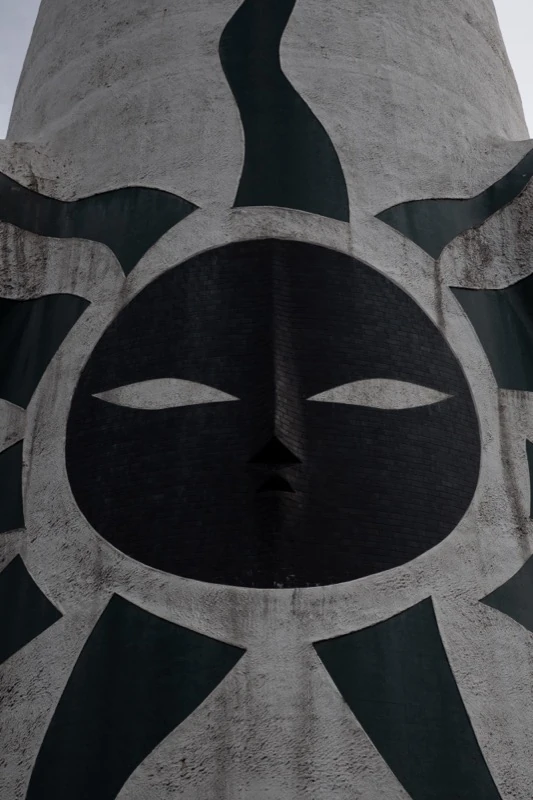 A large face on the side of a tower